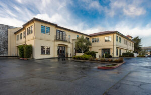 Exterior view of the medical office building and parking area for plastic surgeon Dr. David T. Morwood in Monterey.